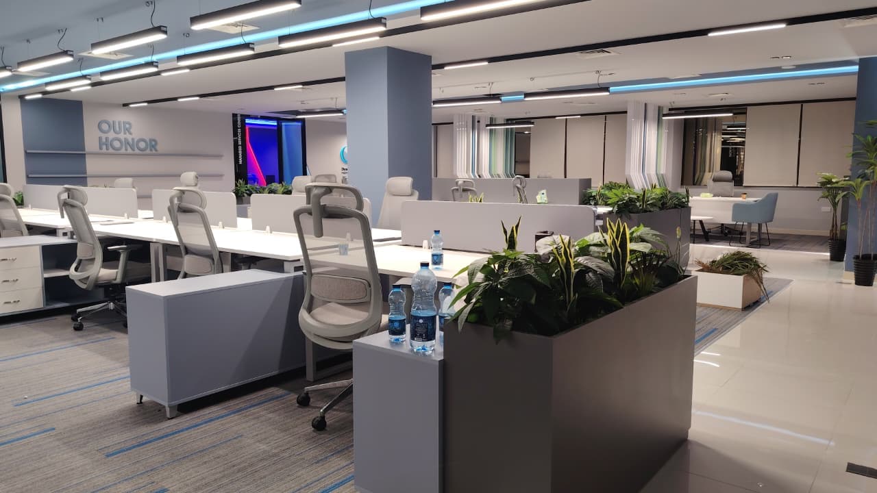 Modern open-plan office with ergonomic chairs